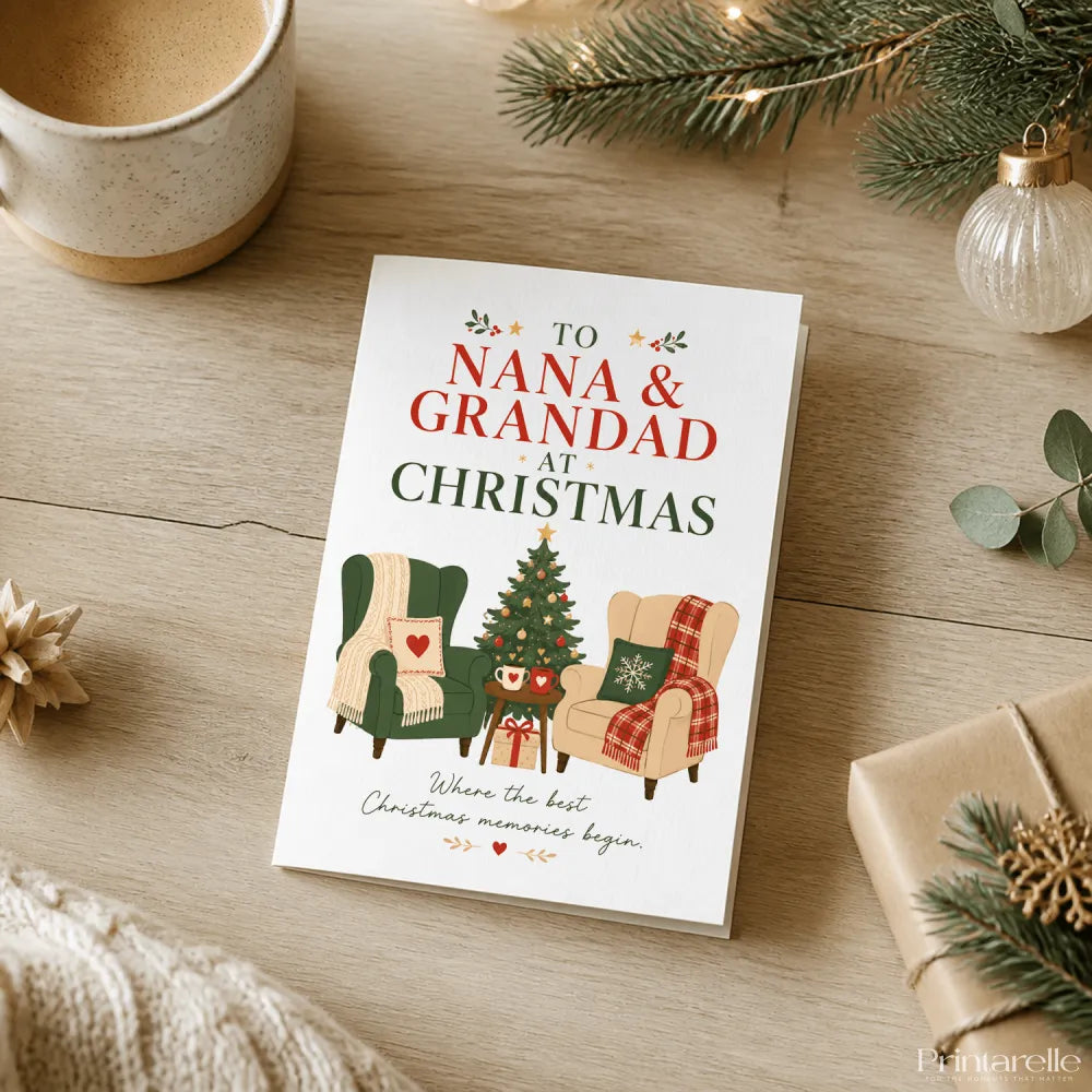 White christmas card featuring a decorated tree gifts and two armchairs with to nana and grandad at christmas text