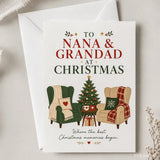 A festive white christmas card with two armchairs, a decorated tree, and to nana and grandad at christmas text