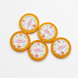Golden 40mm milk chocolate coins with white floral center and pink text clara’s confirmation day 10.04.2026