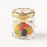 Wildflower blessing personalised mini jar favour with 43mm pale gold lid and cream ribbon filled with colorful gummy candies