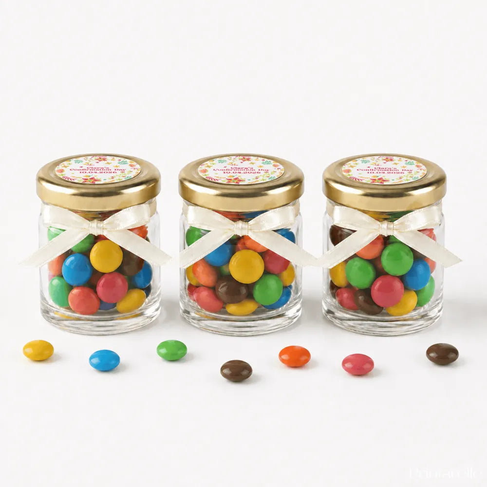 Three clear glass jars with 43mm pale gold lids and personalised sticker printed for wildflower blessing favours