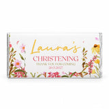 A personalised 40g chocolate bar wrapped in clear foil with pink and yellow floral design for christening thank you