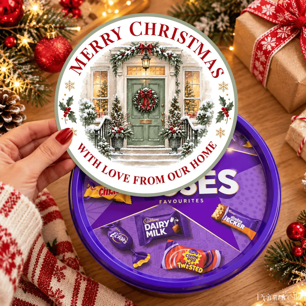 Purple round tin of cadbury chocolate favourites with a merry christmas tub sticker featuring ready printed design door and holly