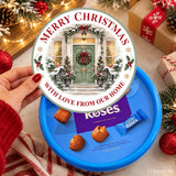 A festive blue cadbury roses tub with a ready printed merry christmas door tub sticker design and holiday decor